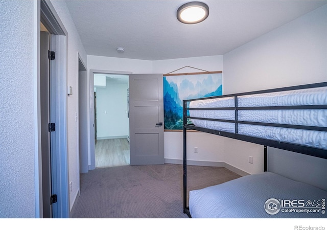 unfurnished bedroom featuring carpet flooring and baseboards