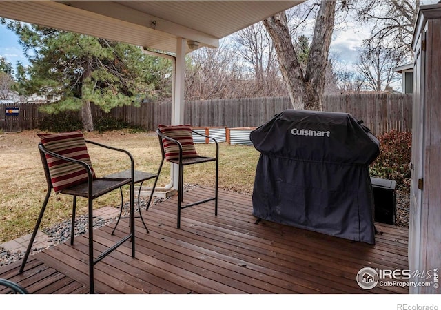 deck featuring area for grilling and a fenced backyard