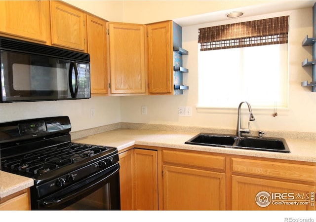 kitchen with a sink, black appliances, open shelves, and light countertops