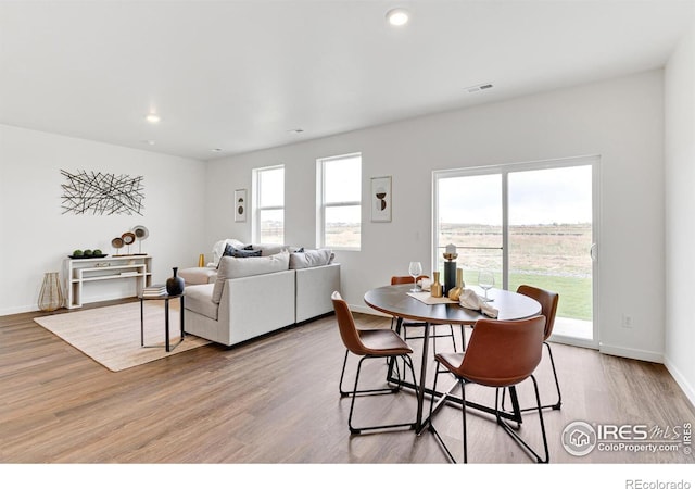 dining room with light wood-style flooring, recessed lighting, visible vents, and baseboards