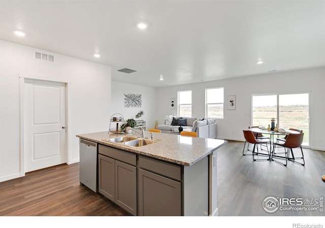 kitchen featuring gray cabinetry, a sink, visible vents, stainless steel dishwasher, and a center island with sink