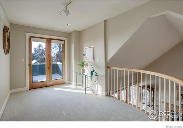 interior space with baseboards, rail lighting, french doors, carpet floors, and recessed lighting