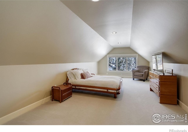 bedroom featuring lofted ceiling, baseboards, and light colored carpet