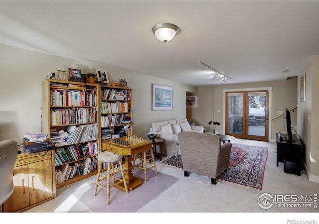 living area with light carpet