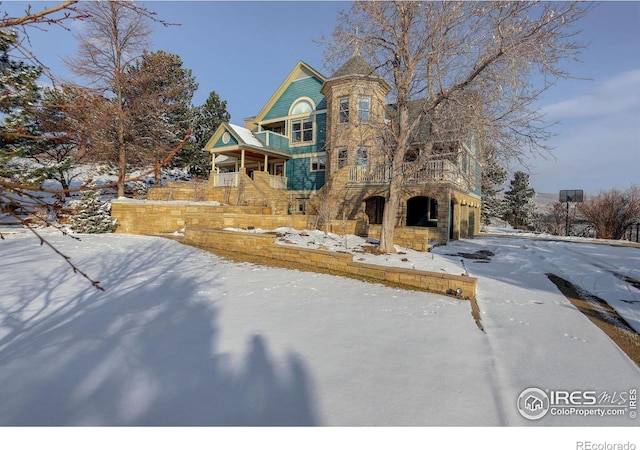 view of front of house featuring a garage and stone siding