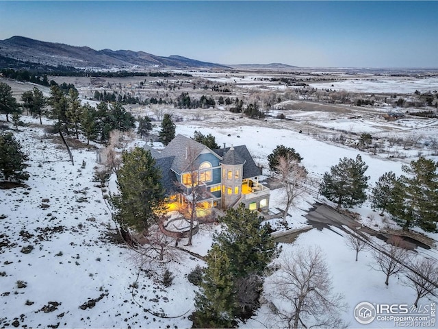 snowy aerial view with a mountain view