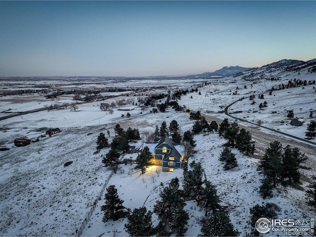 snowy aerial view with a mountain view