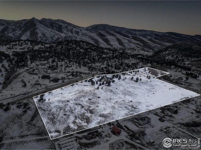 snowy aerial view featuring a mountain view