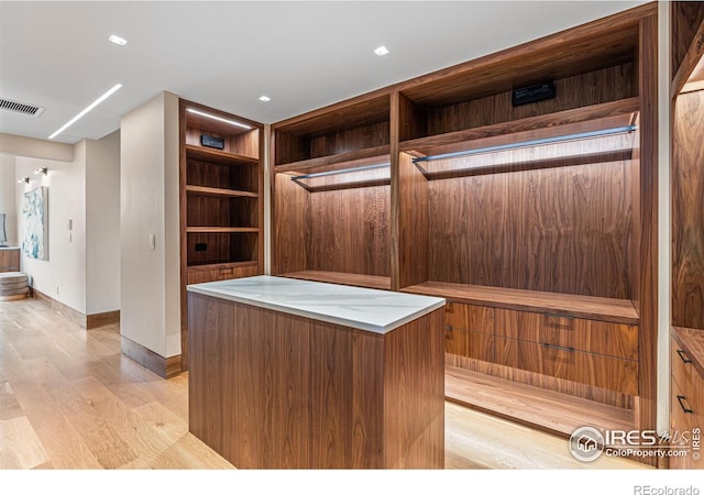 spacious closet featuring light wood-style floors and visible vents