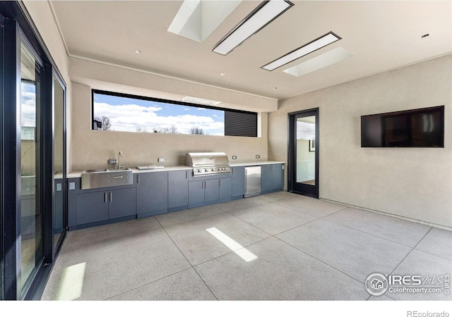 view of patio with a sink, a grill, and an outdoor kitchen