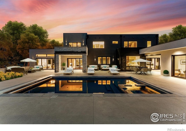 back of house with a patio and an outdoor pool