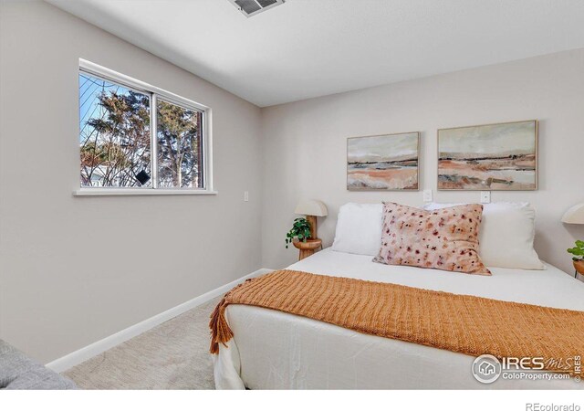 bedroom featuring carpet, visible vents, and baseboards