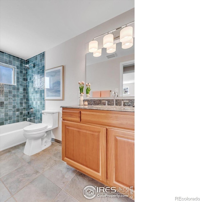 bathroom featuring visible vents, toilet, vanity, shower / tub combination, and tile patterned floors