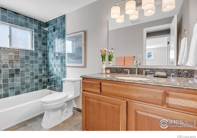 bathroom featuring a wealth of natural light, shower / tub combination, toilet, and tile patterned floors