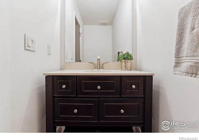 bathroom featuring visible vents and vanity