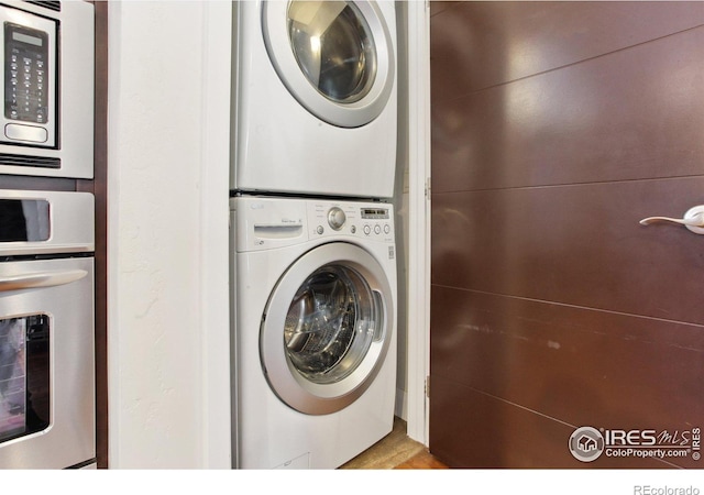 washroom with laundry area and stacked washing maching and dryer