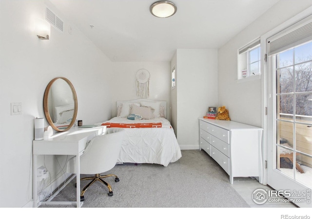 bedroom with visible vents and light carpet