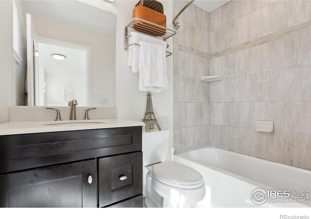 full bathroom featuring toilet, vanity, and washtub / shower combination