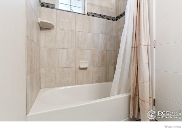 bathroom featuring shower / bath combo with shower curtain