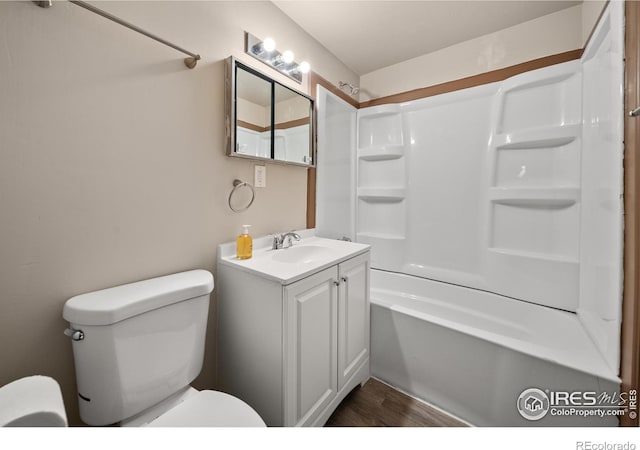 full bathroom with toilet, bathtub / shower combination, wood finished floors, and vanity