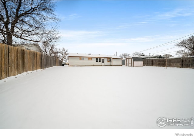 exterior space featuring a fenced backyard, a storage unit, and an outdoor structure