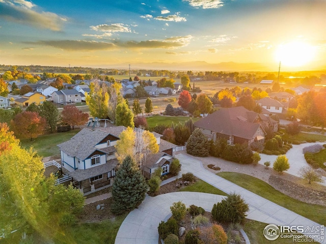 aerial view at dusk featuring a residential view