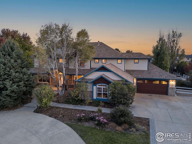 traditional-style home with a garage and driveway