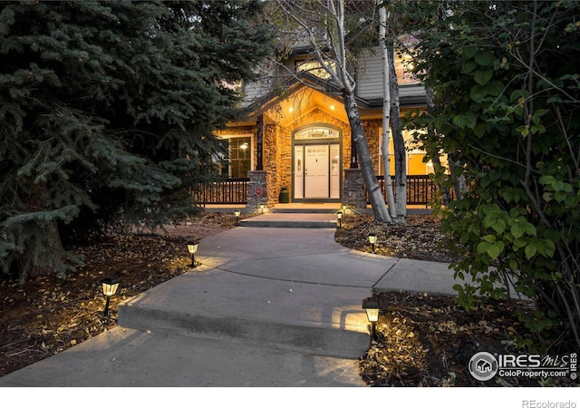 entrance to property featuring stone siding