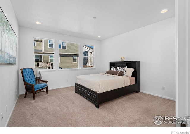 bedroom with recessed lighting, light carpet, and baseboards