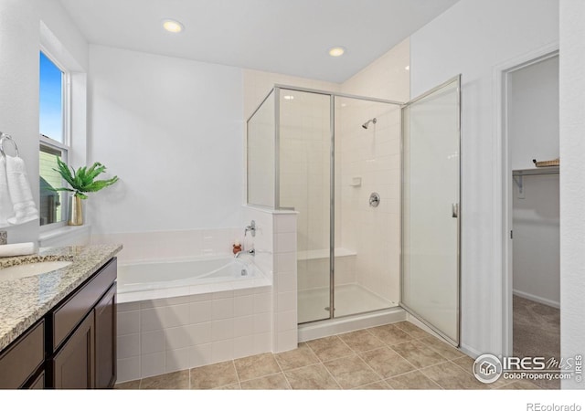 bathroom featuring vanity, tile patterned flooring, a shower stall, and a bath