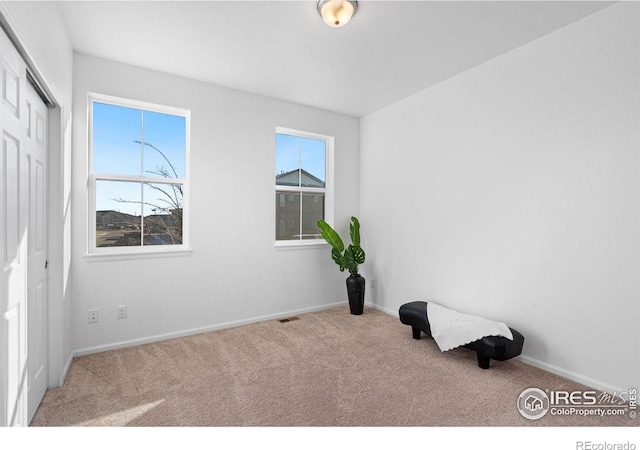 unfurnished bedroom featuring a closet, carpet flooring, visible vents, and baseboards