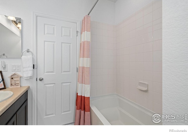 bathroom featuring shower / tub combo and vanity