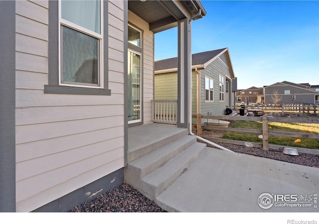 view of side of home featuring fence