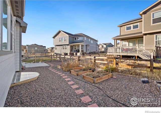 view of yard with a residential view, a vegetable garden, and fence