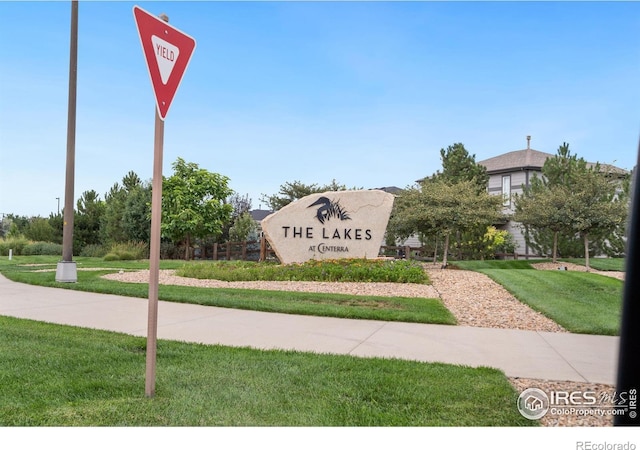 community / neighborhood sign with a lawn