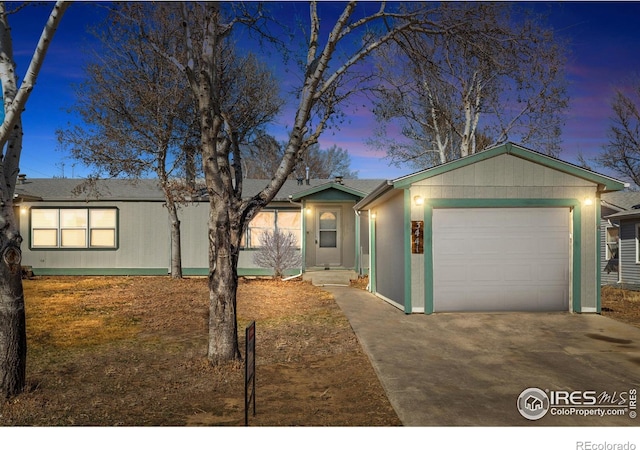 view of front of house with concrete driveway and an attached garage