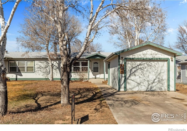 single story home featuring a garage and driveway