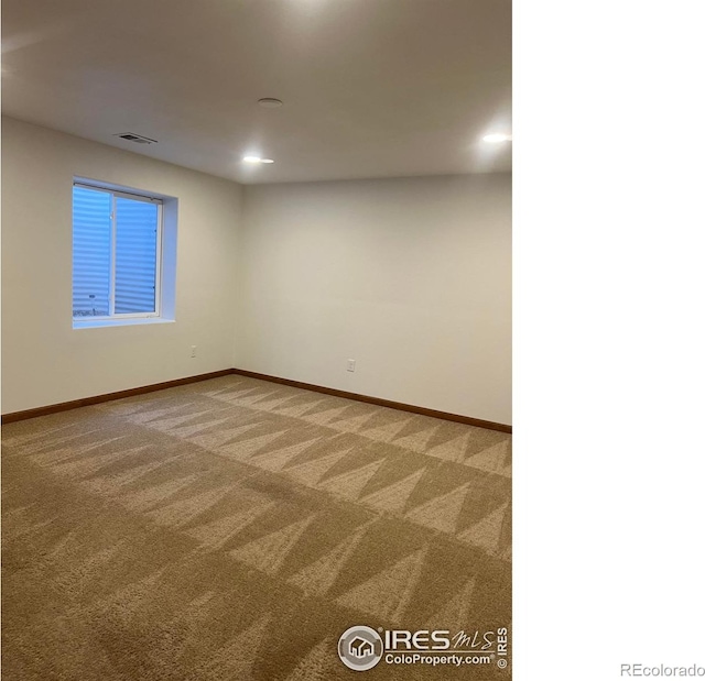 carpeted empty room with recessed lighting, visible vents, and baseboards