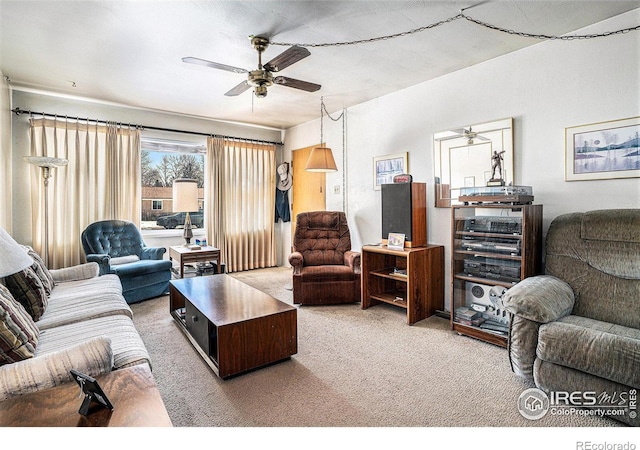 living area featuring light colored carpet and ceiling fan