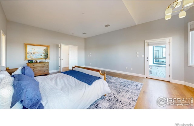 bedroom featuring baseboards and wood finished floors