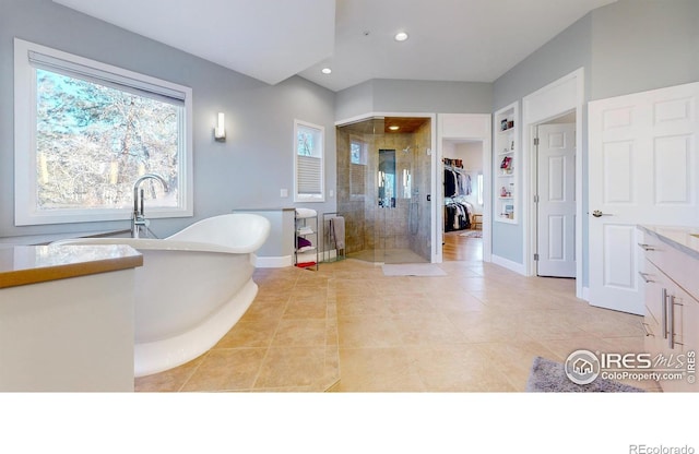 full bathroom featuring recessed lighting, a soaking tub, a stall shower, baseboards, and tile patterned floors