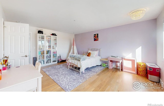 bedroom featuring light wood-style flooring