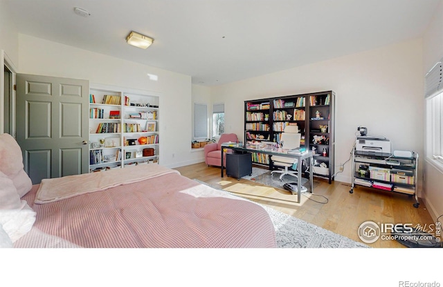 bedroom featuring wood finished floors and baseboards