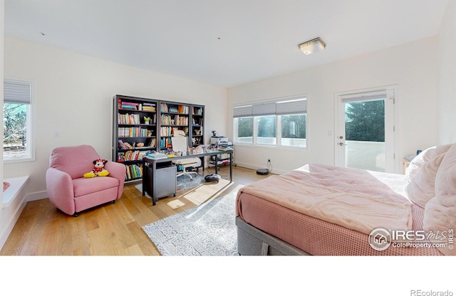 bedroom with wood finished floors and baseboards