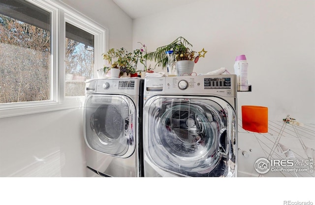 laundry room with laundry area and washing machine and clothes dryer