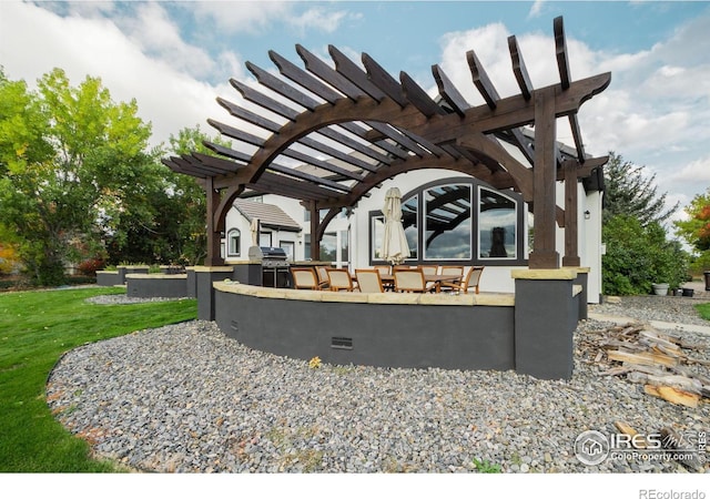 exterior space with a grill and a pergola