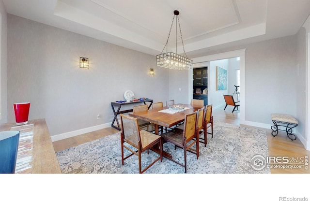 10667 E Goose Haven Dr, Lafayette, CO 80026 - dining room with a raised ceiling, wood finished floors, and baseboards