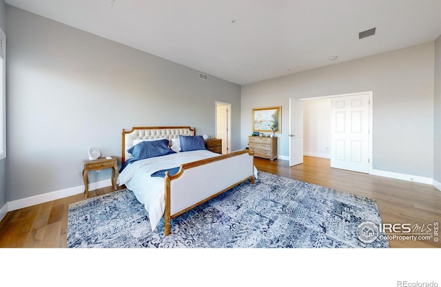 10667 E Goose Haven Dr, Lafayette, CO 80026 - bedroom with wood finished floors and baseboards