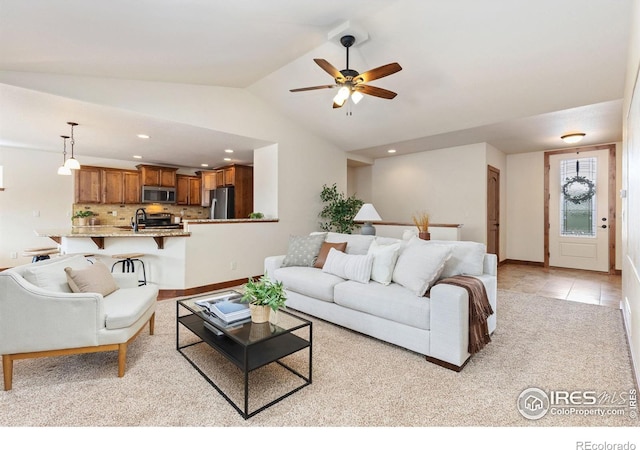 living area with lofted ceiling, ceiling fan, light tile patterned floors, and recessed lighting