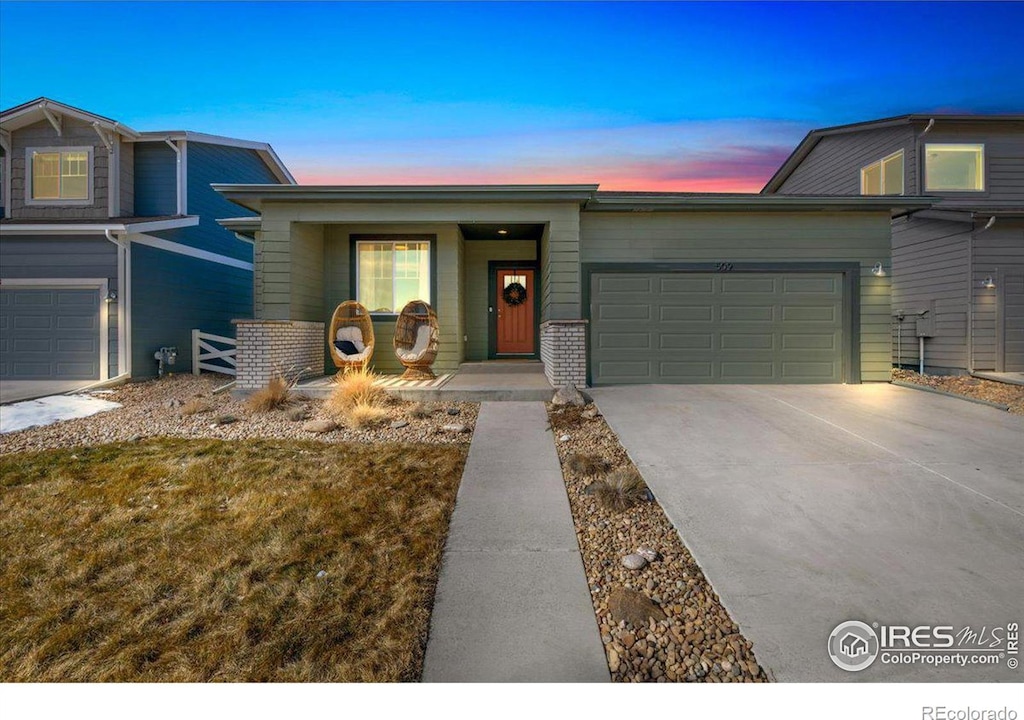 509 Stout St, Fort Collins, CO 80524 - view of front of property featuring driveway, a garage, and brick siding